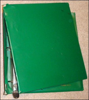 A very well used heavy-duty 3 ring binder, folded. Is it now broken beyond repair?