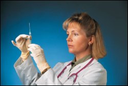 Lady doctor preparing a syringe shot vaccine