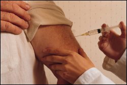 Male patient getting vaccine shot injection.