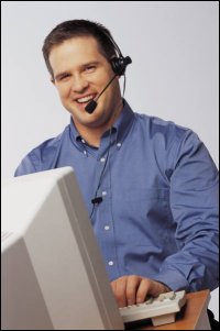 Man with headset on computer, like a driver manager.