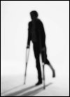 Man leaning on crutches for support.