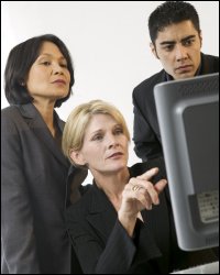 professional woman pointing to computer monitor