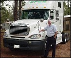 Mike Simons standing in front of a truck he drove for Epes Transport.