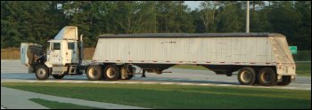 A truck parked with its hood up.