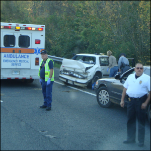 A badly smashed up four wheeled vehicle results in emergency responder help. Sometimes accidents like this happen on New Years Eve.