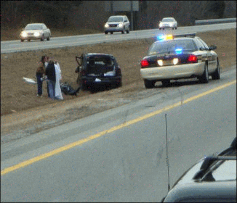 A four wheeled vehicle has swerved off the road into the median of a highway.