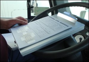 Mike has prepared the paperwork shown on top of the aluminum forms holder so that it can be scanned and he can get paid.