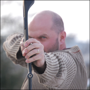 Man ready to shoot an arrow straight at me, symbolic of handing someone ammo to harm you.