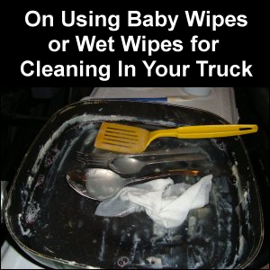 Using baby wipes instead of dishcloths to clean dishes after preparing a meal in-truck.