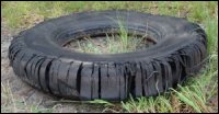A discarded used tire, past the point of being retreaded.