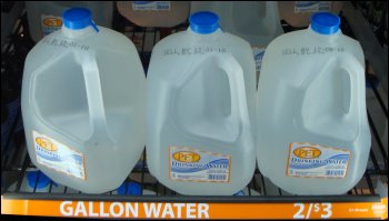 A display of one-gallon containers of bottled water for sale at a truck stop. You may find them either refrigerated, as shown here, or not refrigerated.