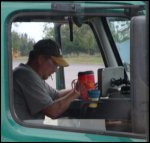 Cigarette smoking professional truck driver; picture taken from passenger side of truck.