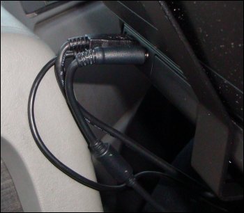 This close-up shows that the proximity of the wires and cables from the back of the laptop with the truck's dash could damage the former during the tractor's movement.
