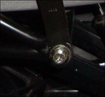 This close-up photo shows that the tubing connected at the seat belt is not flat far enough up to allow the buckle to rotate freely. Instead, it is held at a very odd angle.
