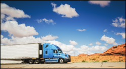 Truck on road with blue sky in background