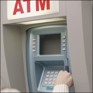 Lady getting a withdrawal from an ATM. Did she have to pay a foreign ATM fee?