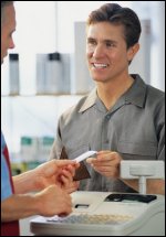 customer handing card to clerk