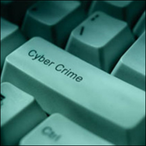 Key on computer keyboard reads 'cyber crime'.
