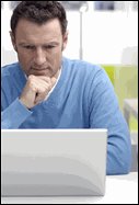Man looking at a laptop computer.