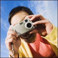 Man taking a photo with a camera.