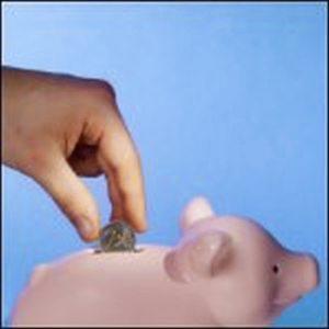Putting money in a piggy bank for savings.