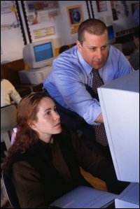 Teacher and student at computer.