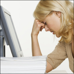 A woman receives bad news over the computer.