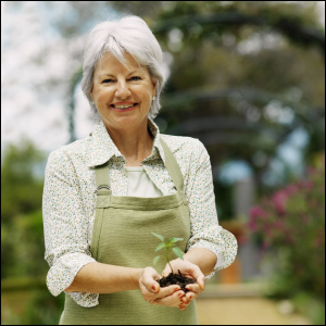 Woman with seedling plant in hands.