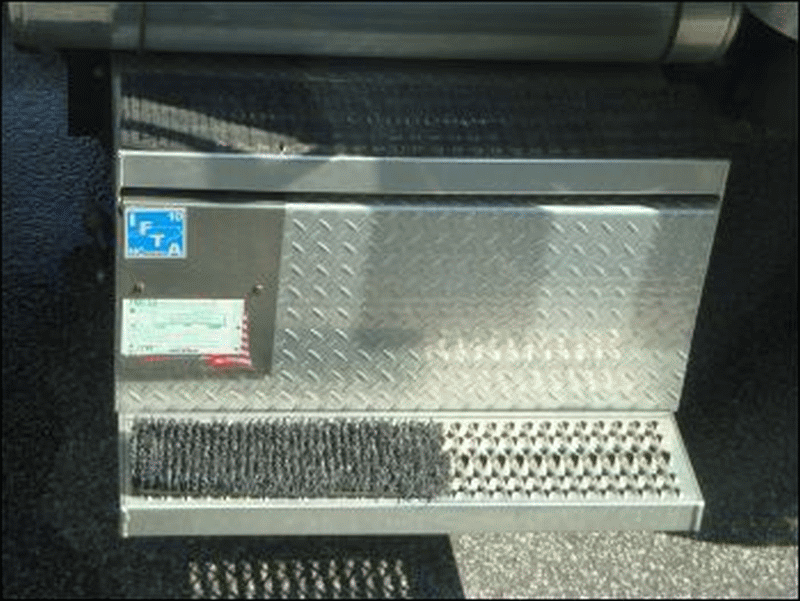 A door mat or boot mat on the lower step of a truck.