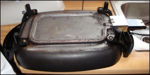 electric skillet bottom showing the attachment of handles/legs