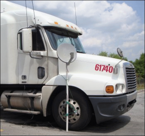 A satellite dish mounted on the side of a truck.