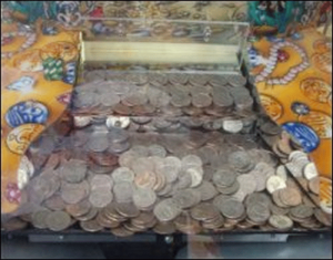 Close-up of a coin pusher game at a truck stop.