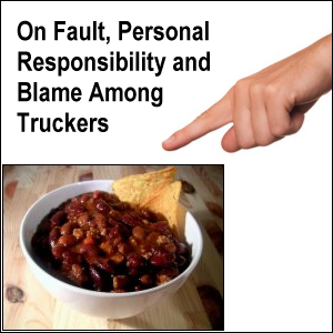 Pointing to a bowl of chili with two nacho chips.