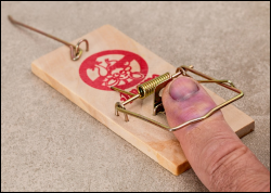 Finger in mousetrap symbolizes being trapped or having made a bad decision.