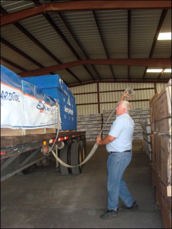 Getting ready to thrown an inspected load strap over the top of the load.