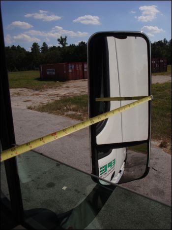 Measuring the distance between the edge of the mirror and the side of the truck in its fully extended position -- between 17 and 18 inches.