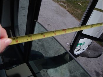 Measuring the distance from the outside edge of the mirror to the passenger side window -- about 17 inches.