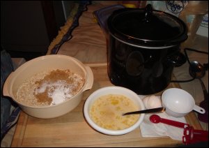 Preparing Amish Baked Oatmeal, the dry ingredients on the left, the wet ingredients in the foreground, the crock pot in the background.