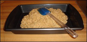 Amish Baked Oatmeal mixture being spread in a baking pan.