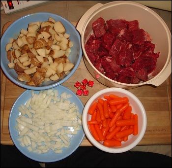 The ingredients for our beef stew are potatoes, beef, carrots, onion and beef bouillon. Water is not shown.