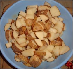 Cleaned and diced potatoes, ready to be added to a crock pot to make beef stew.