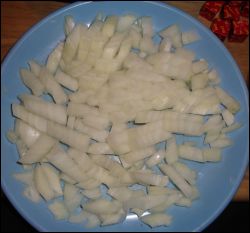 Diced onion, ready to be added to the crock pot for beef stew.