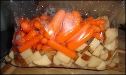Diced potatoes and baby carrots in a bag, prepared for adding to the crock pot for beef stew.