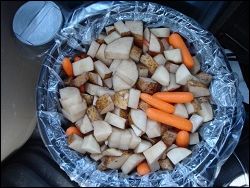 The potatoes and carrots are put on top of the meat, onions, bouillon and water part way through the cooking cycle.