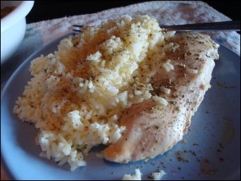 Chicken and rice with sage sprinkled on top.