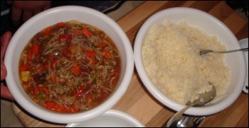 Chinese food: Prepared beef chow mein and rice in separate bowls.