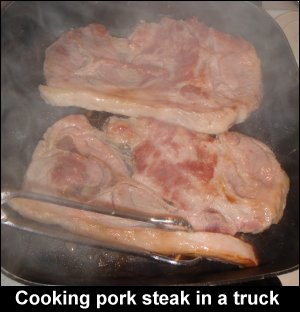 Cooking pork steak in a truck.