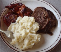 Mashed potatoes with entree items, served from a truck stop restaurant buffet.