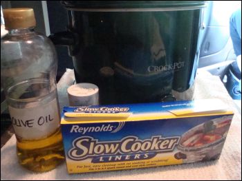 Crock pot with slow cooker liner, oil and salt.