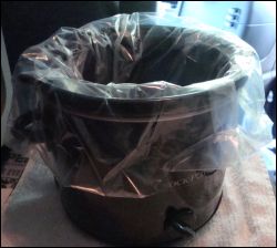 Crock pot with slow cooker liner inserted.